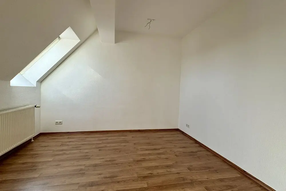 An empty attic room, then staged as a Scandinavian sitting room.