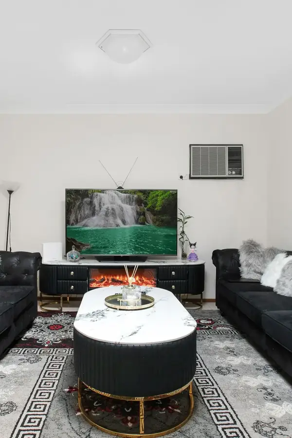 Great room staged in a dark palette, as a pin