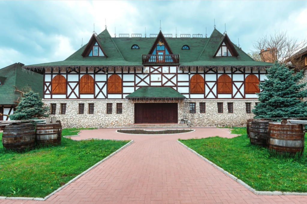 Front exterior of a large European-style home with timber framing and symmetrical design, illustrating a strong first impression that delivers key information quickly.