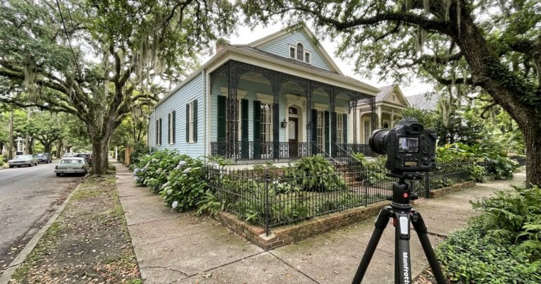 Camera on tripod facing a New Orleans home, illustrating work of real estate photographers new orleans